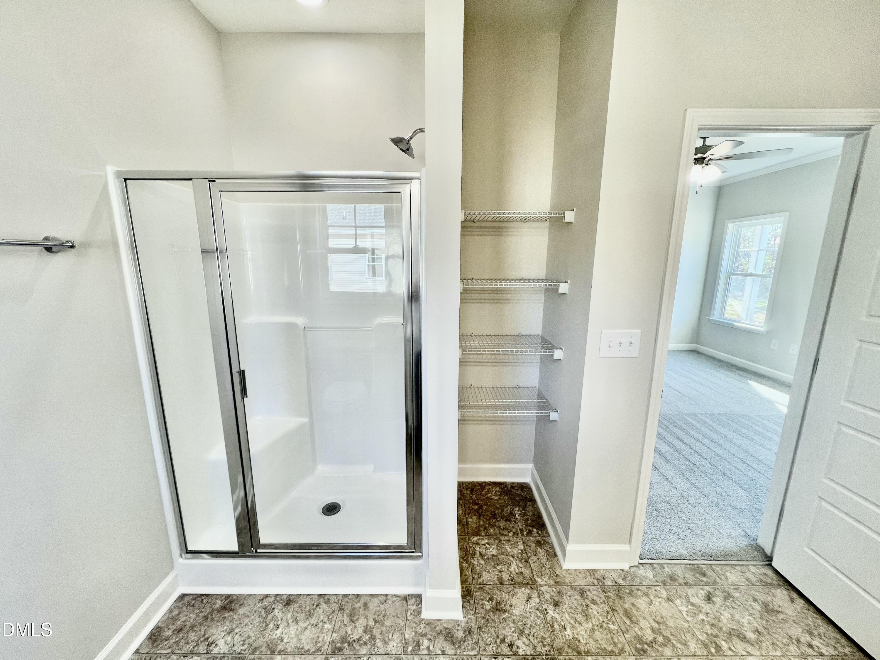 711 Polly Watson Road Fremont, NC 27830 - Photo 11 of 21 a view of a bathroom with a glass door shower and vanity