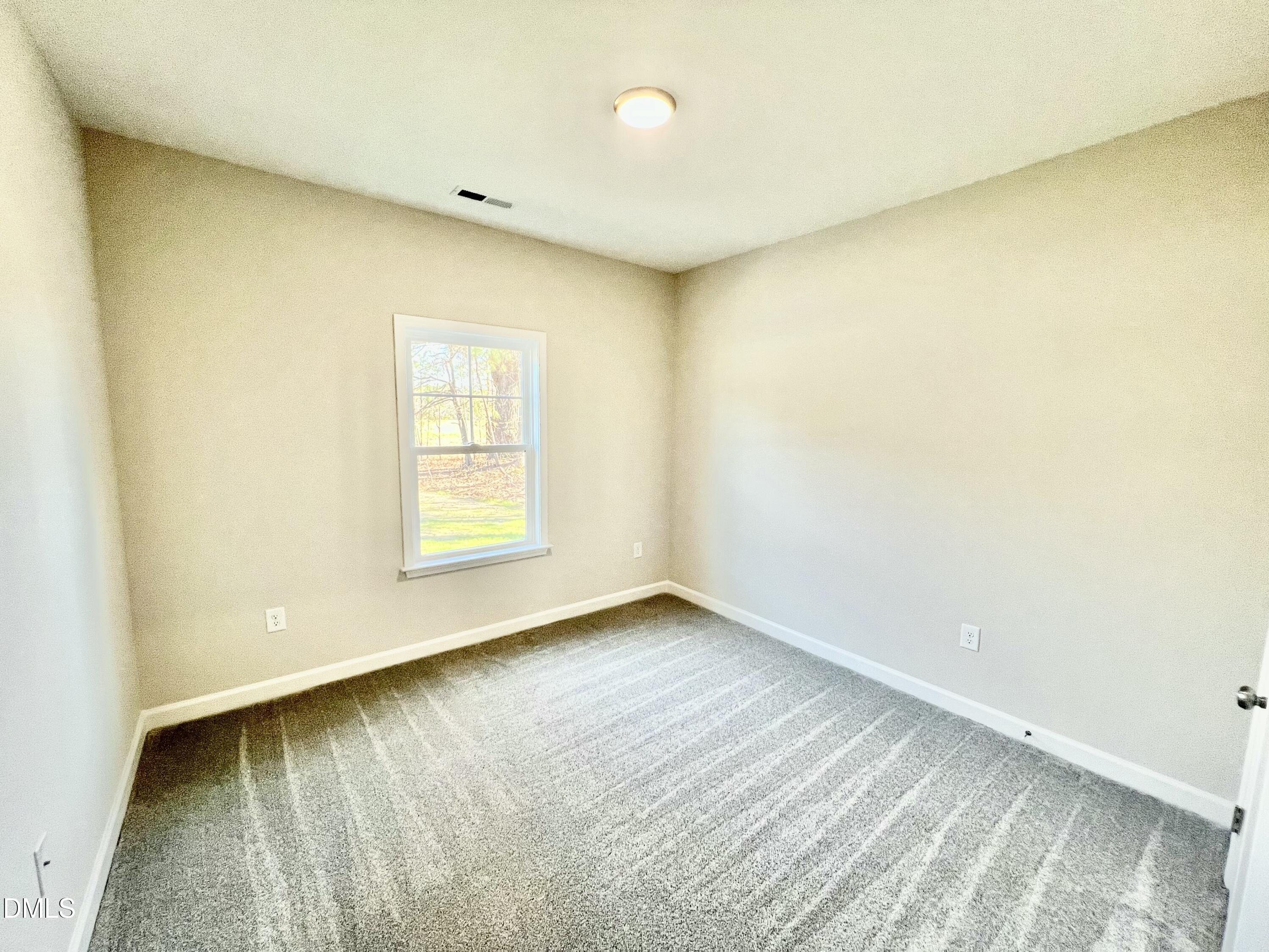 711 Polly Watson Road Fremont, NC 27830 - Photo 12 of 21 a view of an empty room with a window