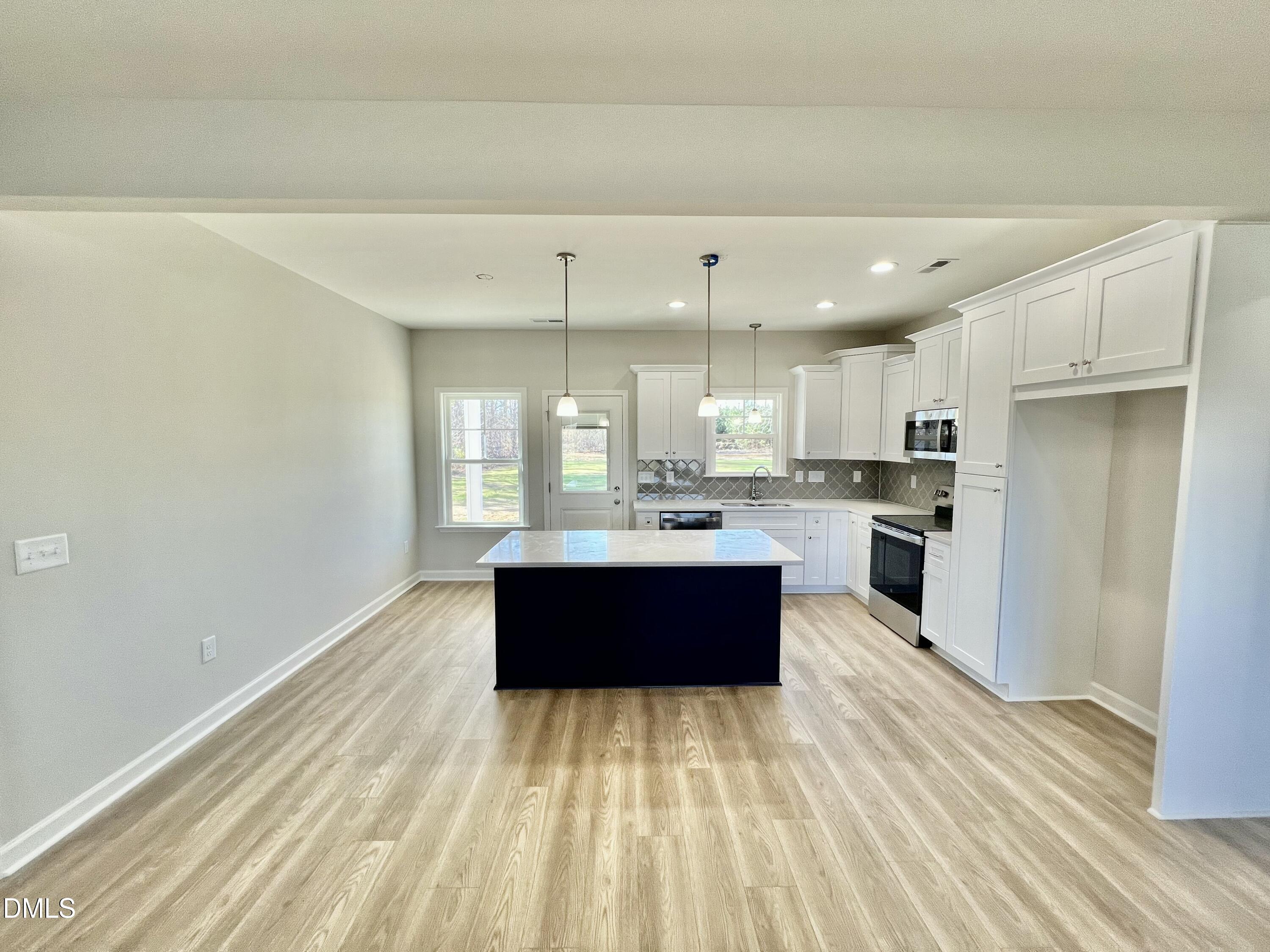 711 Polly Watson Road Fremont, NC 27830 - Photo 5 of 21 a large kitchen with stainless steel appliances kitchen island wooden cabinets and a sink