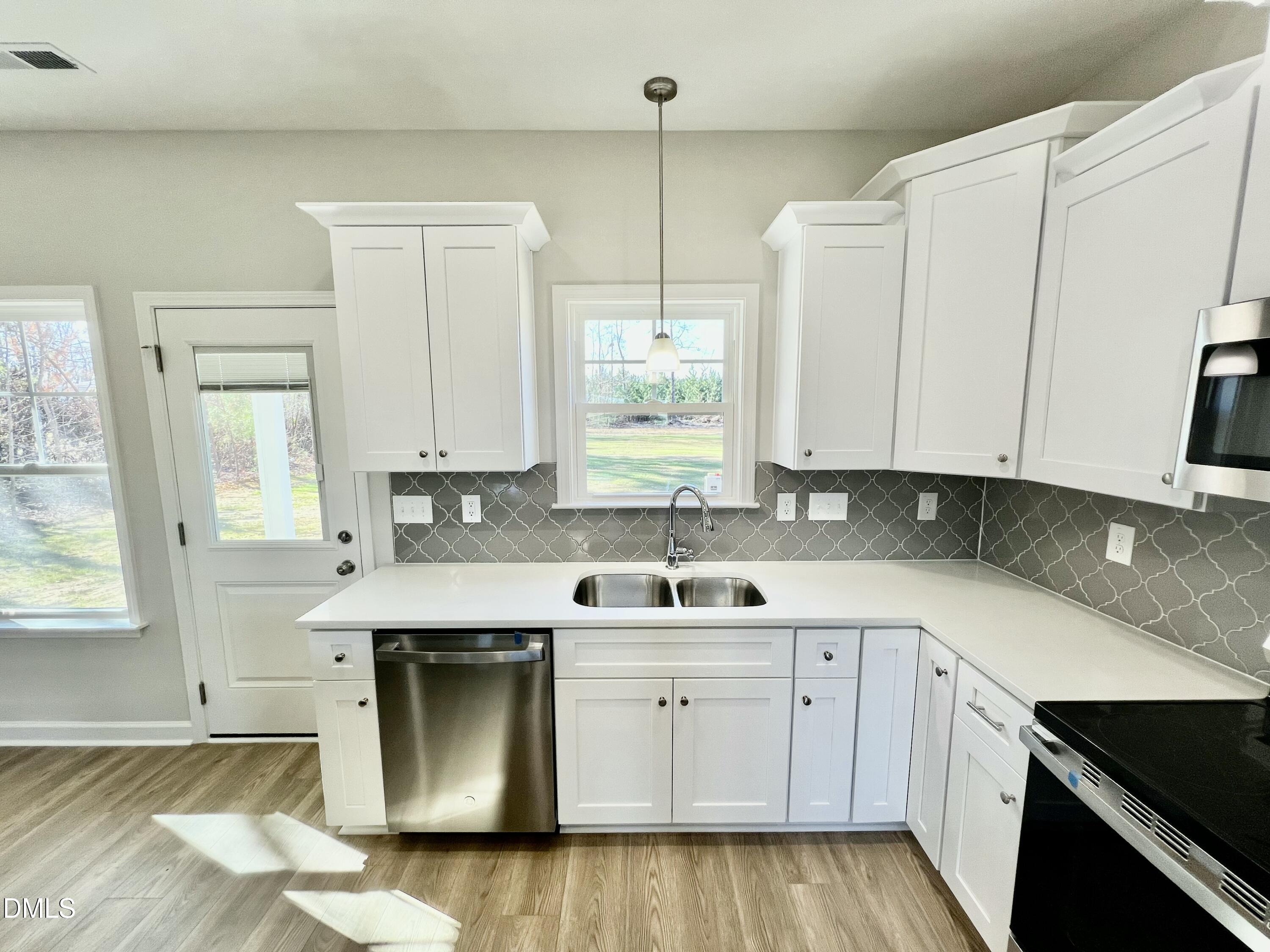 711 Polly Watson Road Fremont, NC 27830 - Photo 7 of 21 a kitchen with stainless steel appliances white cabinets and a sink