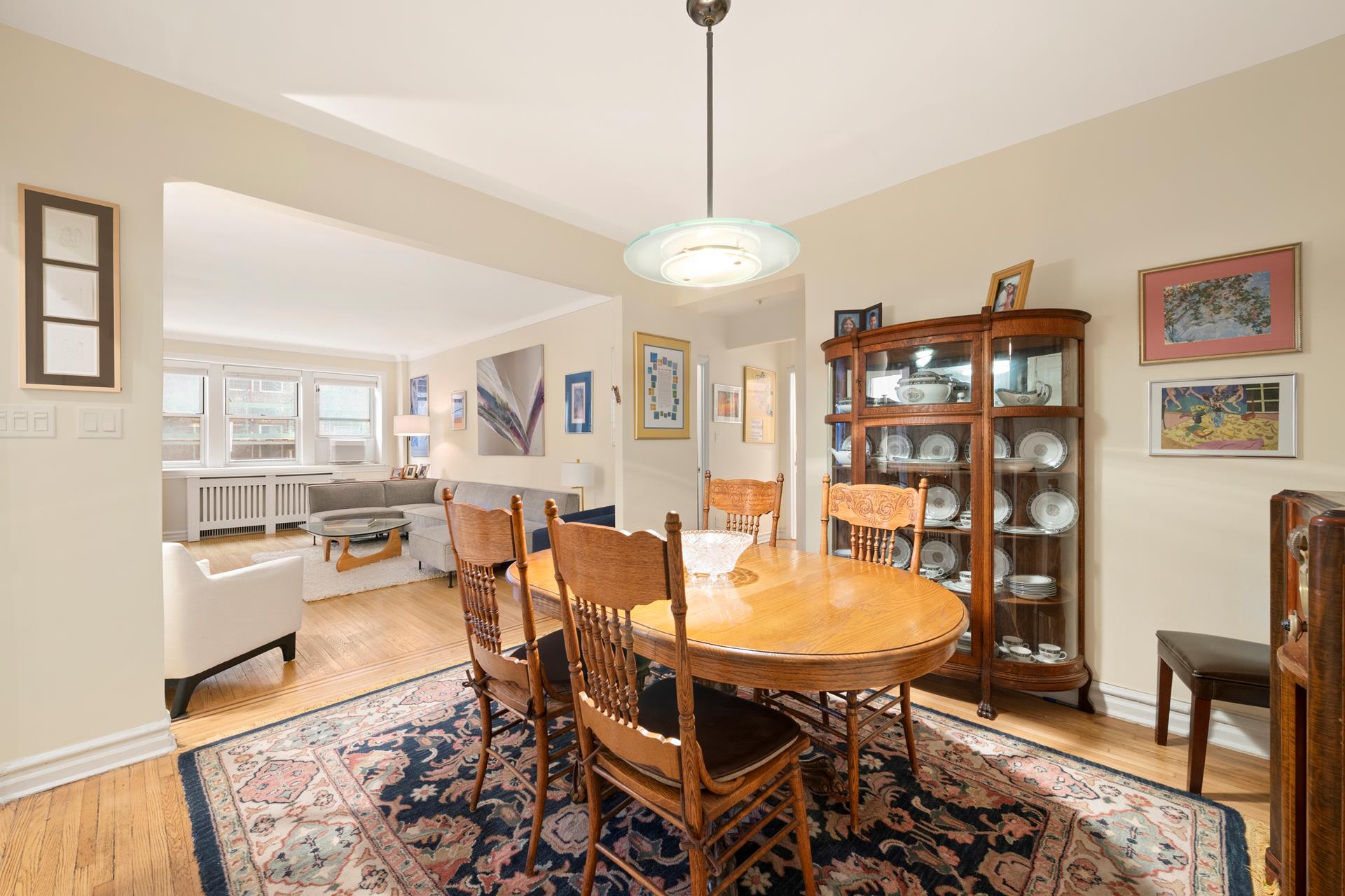86-10 34th Avenue, Unit 113 Queens, NY 11372 - Photo 1 of 13 a dining room with furniture and wooden floor