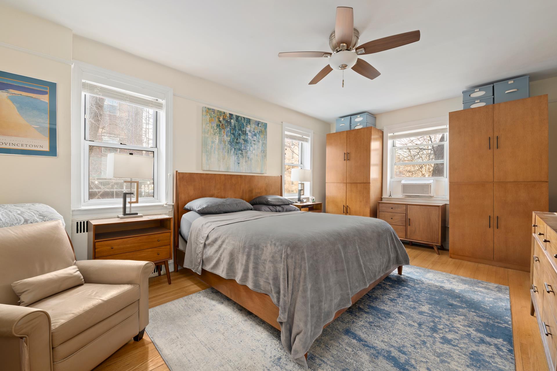 86-10 34th Avenue, Unit 113 Queens, NY 11372 - Photo 8 of 13 a bedroom with a bed couch and window