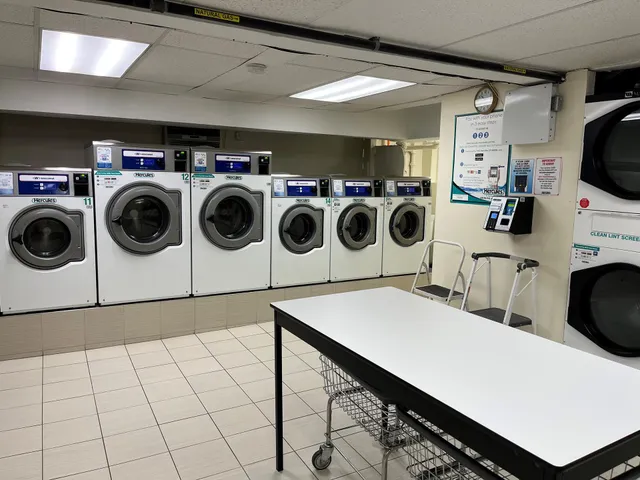 a living room with furniture a refrigerator and a dining table with wooden floor