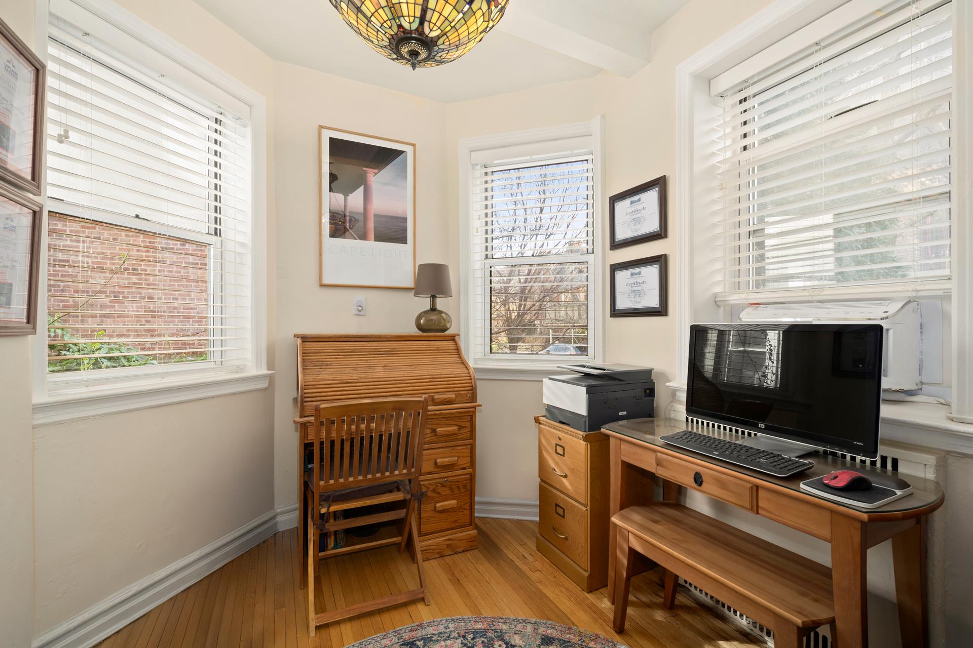 86-10 34th Avenue, Unit 113 Queens, NY 11372 - Photo 2 of 13 a room with furniture and a flat screen tv