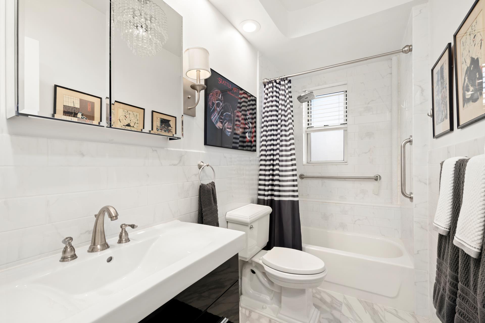 86-10 34th Avenue, Unit 113 Queens, NY 11372 - Photo 3 of 13 a bathroom with a sink toilet and shower