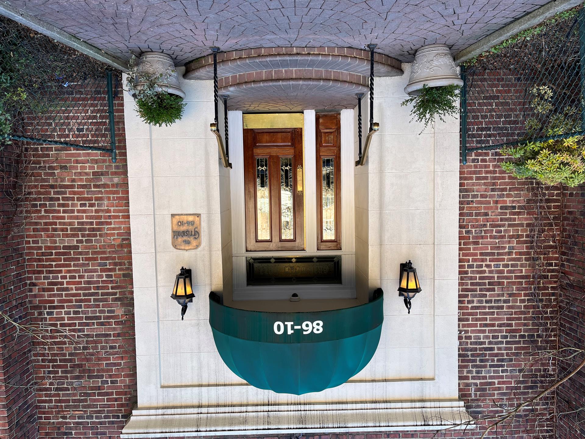 86-10 34th Avenue, Unit 113 Queens, NY 11372 - Photo 11 of 13 a front view of a house with a potted plant