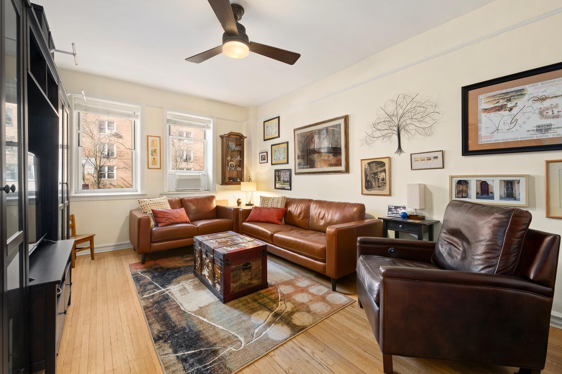86-10 34th Avenue, Unit 113 Queens, NY 11372 - Photo 4 of 13 a living room with furniture and a flat screen tv