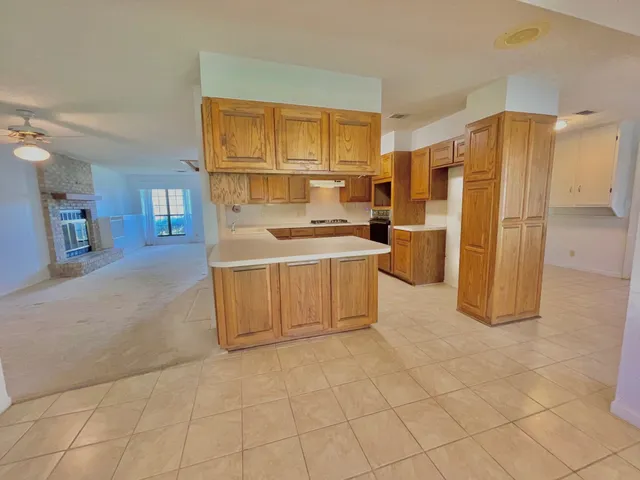 a view of a kitchen with cabinet and refrigerator