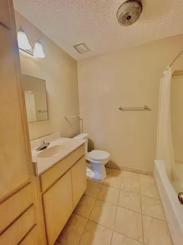 an empty room with a ceiling fan and window