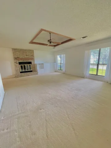 a view of a livingroom with a ceiling fan and a window