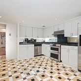 a kitchen with granite countertop a refrigerator and a sink