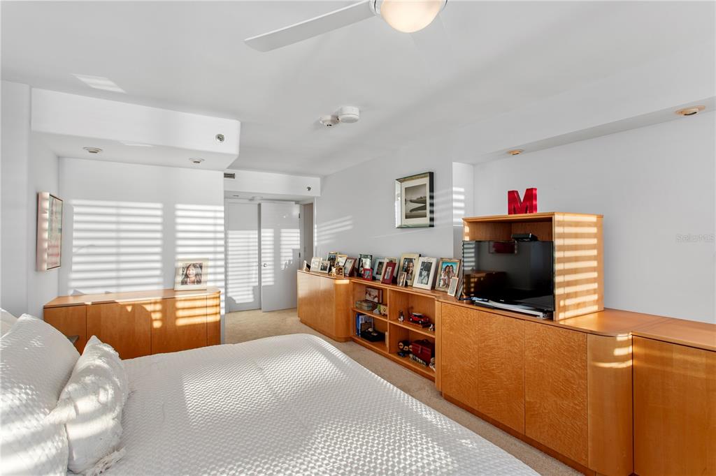775 Longboat Club Road, Unit 808 Longboat Key, FL 34228 - Photo 21 of 41 a large bedroom with furniture and a flat screen tv