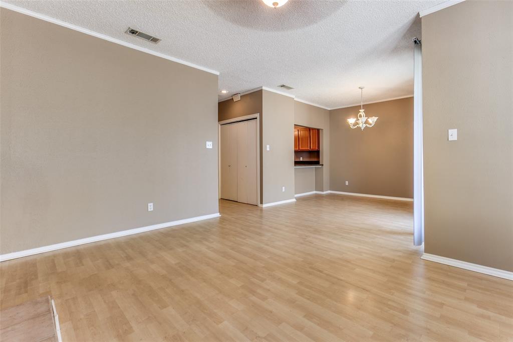 5310 Keller Springs Road, Unit 138 Dallas, TX 75248 - Photo 3 of 12 a view of an empty room with wooden floor