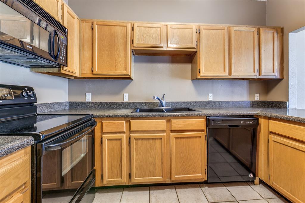 5310 Keller Springs Road, Unit 138 Dallas, TX 75248 - Photo 5 of 12 a kitchen with stainless steel appliances granite countertop a stove and a sink