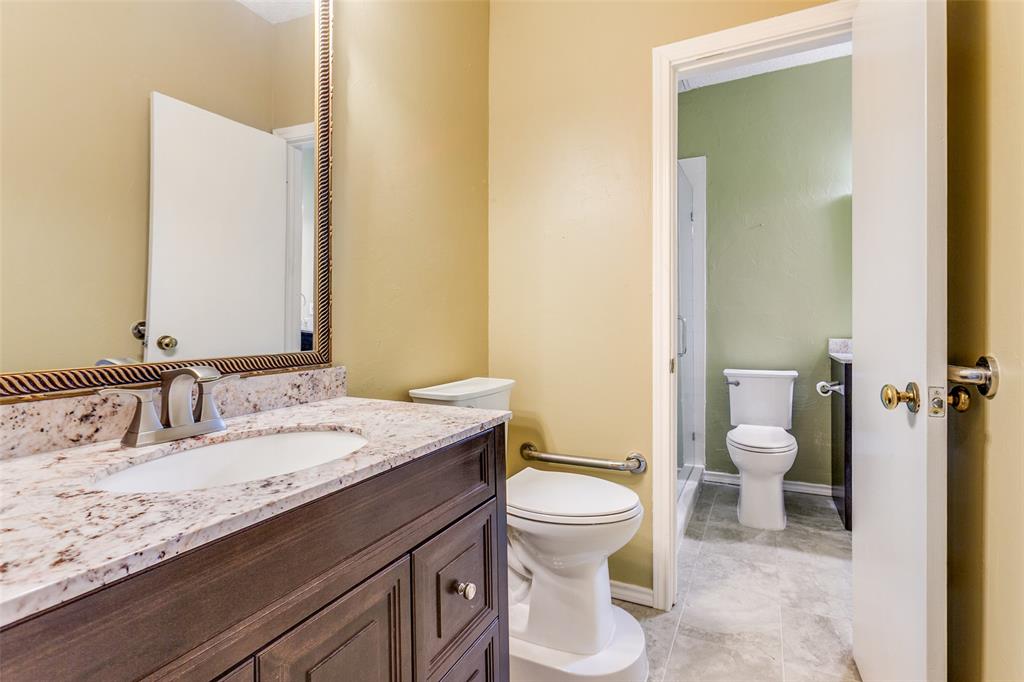 5310 Keller Springs Road, Unit 138 Dallas, TX 75248 - Photo 8 of 12 a bathroom with a granite countertop toilet sink and mirror