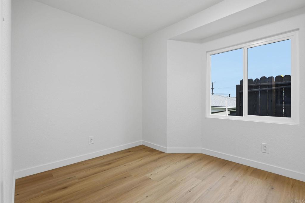 1333 Helix Street Spring Valley, CA 91977 - Photo 30 of 45 a view of an empty room with wooden floor with a window
