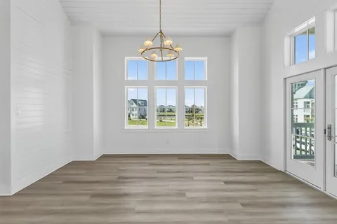 a view of a kitchen with wooden floor and windows