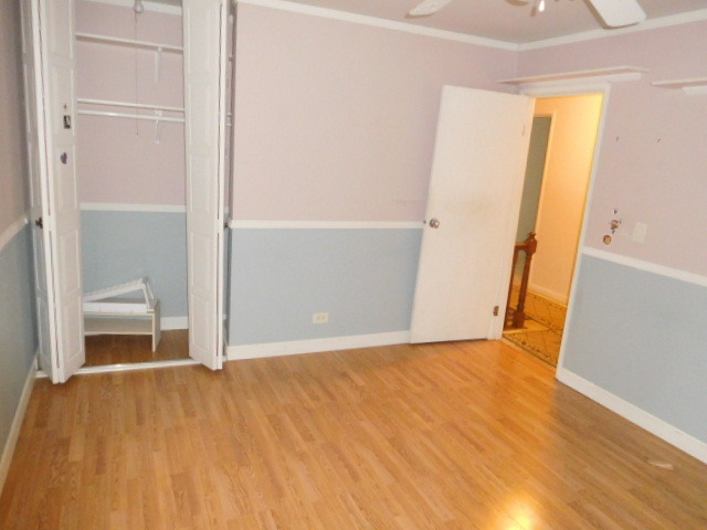 450 Rothbury Drive Bolingbrook, IL 60440 - Photo 11 of 15 a view of an empty room with wooden floor and a window
