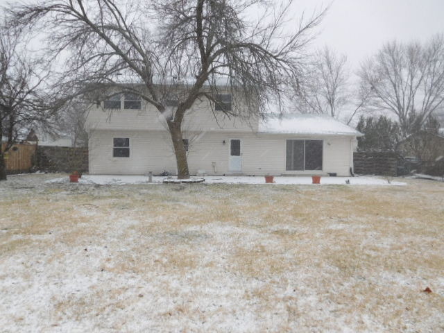 450 Rothbury Drive Bolingbrook, IL 60440 - Photo 14 of 15 a view of house with yard and trees in the background