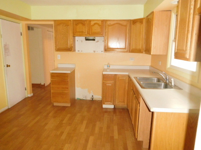 450 Rothbury Drive Bolingbrook, IL 60440 - Photo 6 of 15 a kitchen with a sink a stove and cabinets