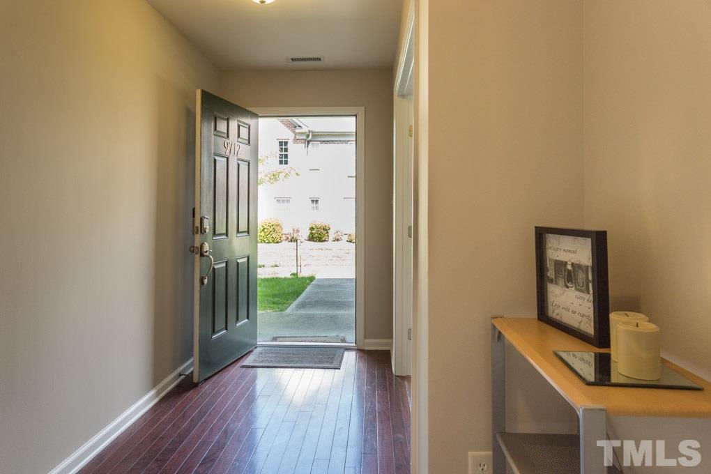 9712 Jordy Drive, Unit 291 Raleigh, NC 27617 - Photo 2 of 15 a view of a hallway with wooden floor and a living room