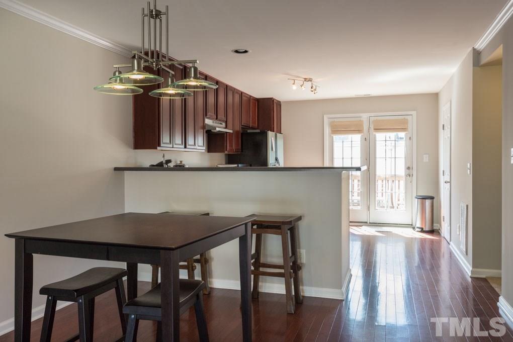 9712 Jordy Drive, Unit 291 Raleigh, NC 27617 - Photo 5 of 15 a view of a dining room with furniture window and wooden floor