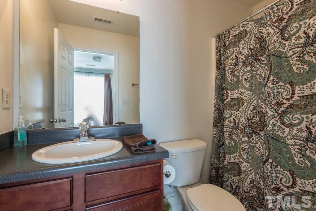 9712 Jordy Drive, Unit 291 Raleigh, NC 27617 - Photo 10 of 15 a bathroom with a granite countertop toilet sink and mirror