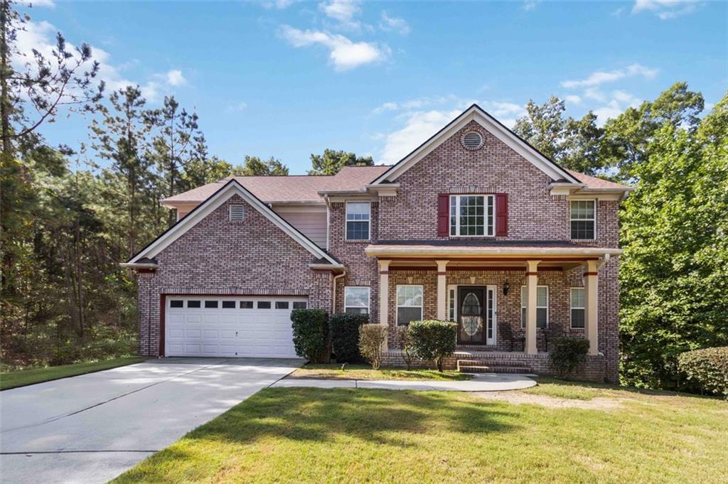 a view of house with yard in front of it