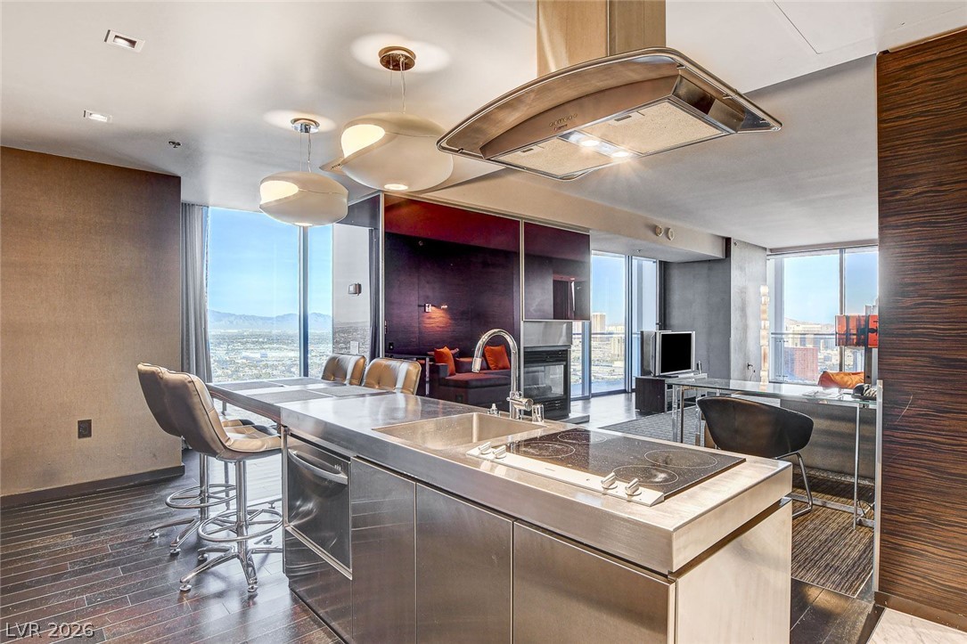 4381 West Flamingo Road, Unit 3002 Las Vegas, NV 89103 - Photo 12 of 59 Gleaming metal countertops and soaring windows define this open-concept culinary space.