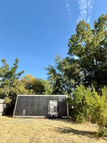 a view of a wooden door and a yard
