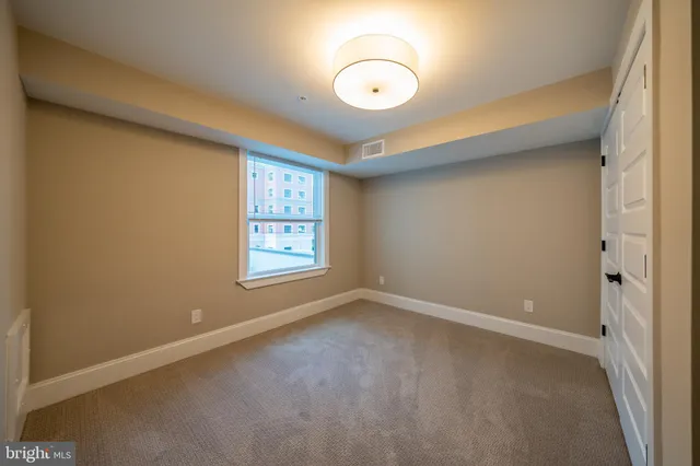 an empty room with closet area