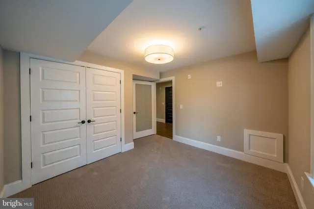 a utility room with washing machine and a view of bedroom