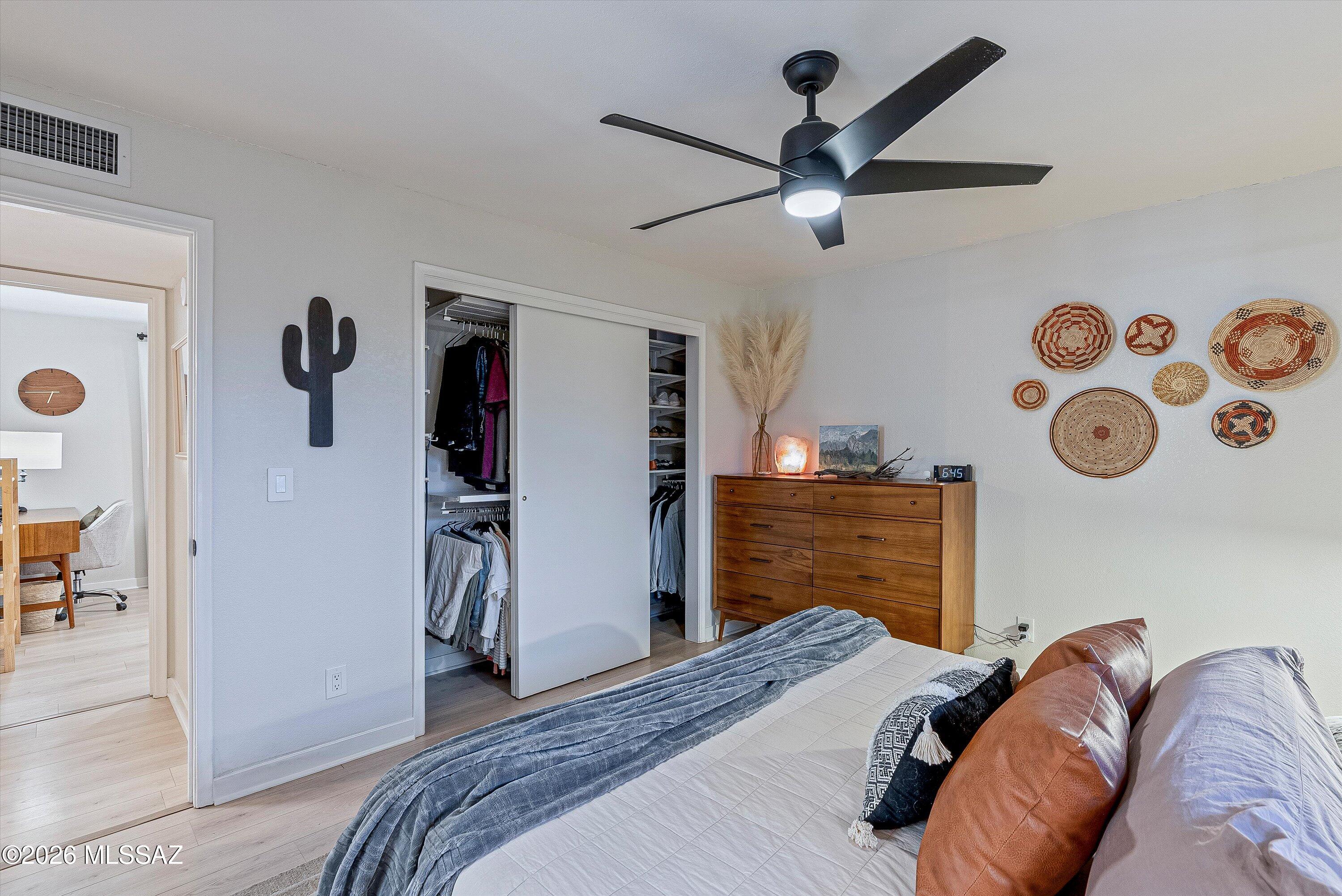 3949 West Mars Street Tucson, AZ 85741 - Photo 14 of 27 a bedroom with a bed and a chandelier