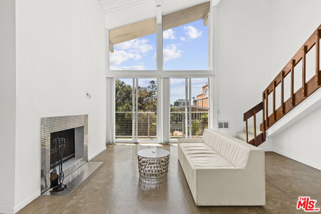 25 Spinnaker Street, Unit 12 Marina del Rey, CA 90292 - Photo 1 of 29 a living room with furniture and a fireplace