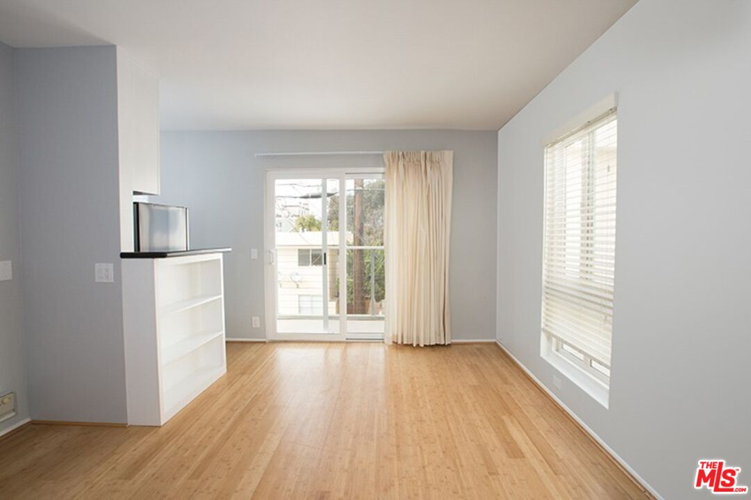 25 Spinnaker Street, Unit 12 Marina del Rey, CA 90292 - Photo 18 of 29 a view of an empty room with wooden floor and a window