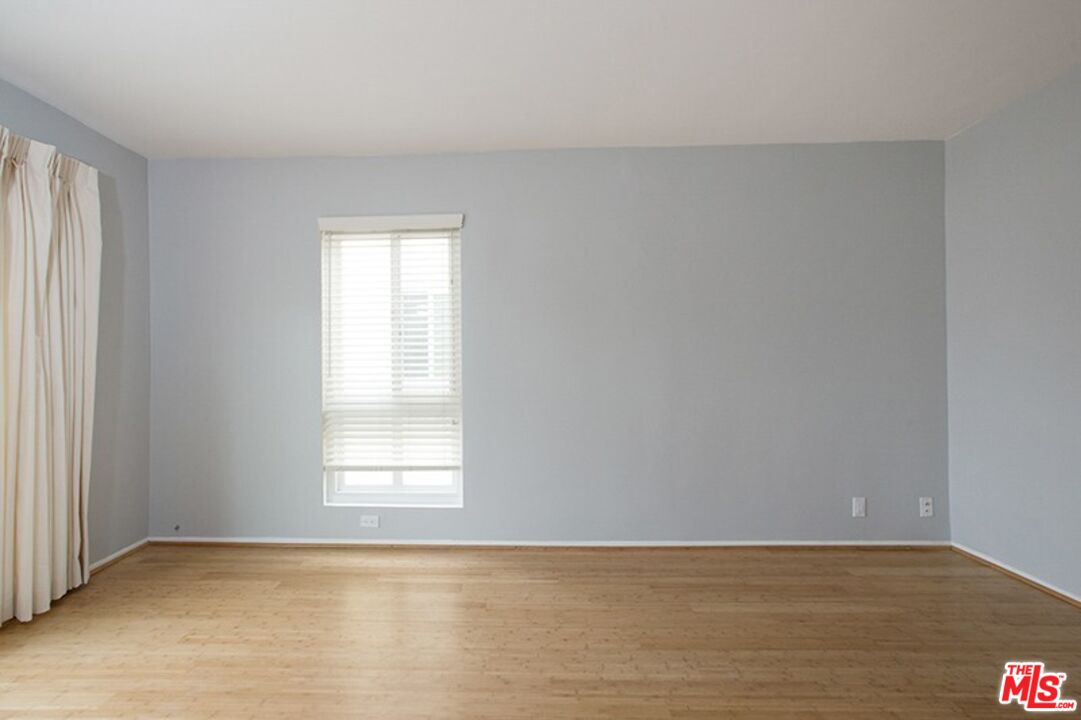 25 Spinnaker Street, Unit 12 Marina del Rey, CA 90292 - Photo 19 of 29 a view of an empty room with wooden floor and a window