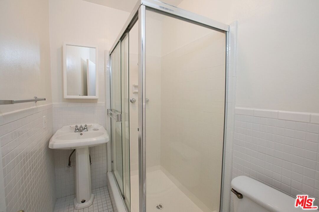 25 Spinnaker Street, Unit 12 Marina del Rey, CA 90292 - Photo 24 of 29 a bathroom with a sink a mirror and a shower