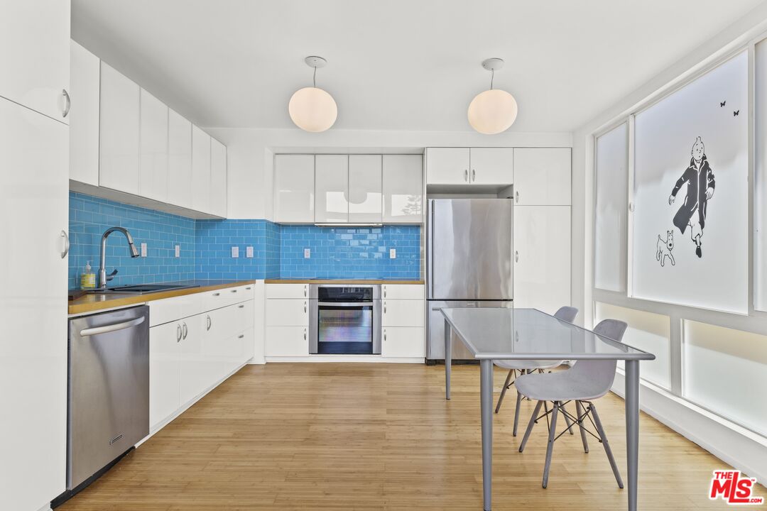 25 Spinnaker Street, Unit 12 Marina del Rey, CA 90292 - Photo 5 of 29 a kitchen with stainless steel appliances granite countertop a stove a sink and a refrigerator