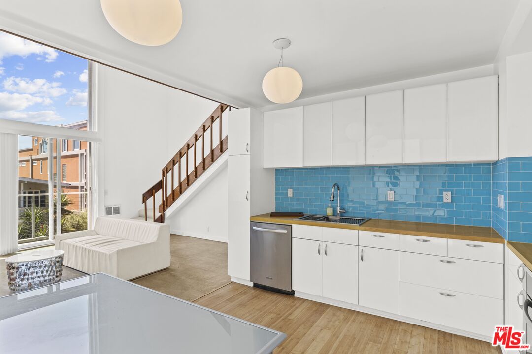 25 Spinnaker Street, Unit 12 Marina del Rey, CA 90292 - Photo 6 of 29 a kitchen with granite countertop a sink a stove and cabinets