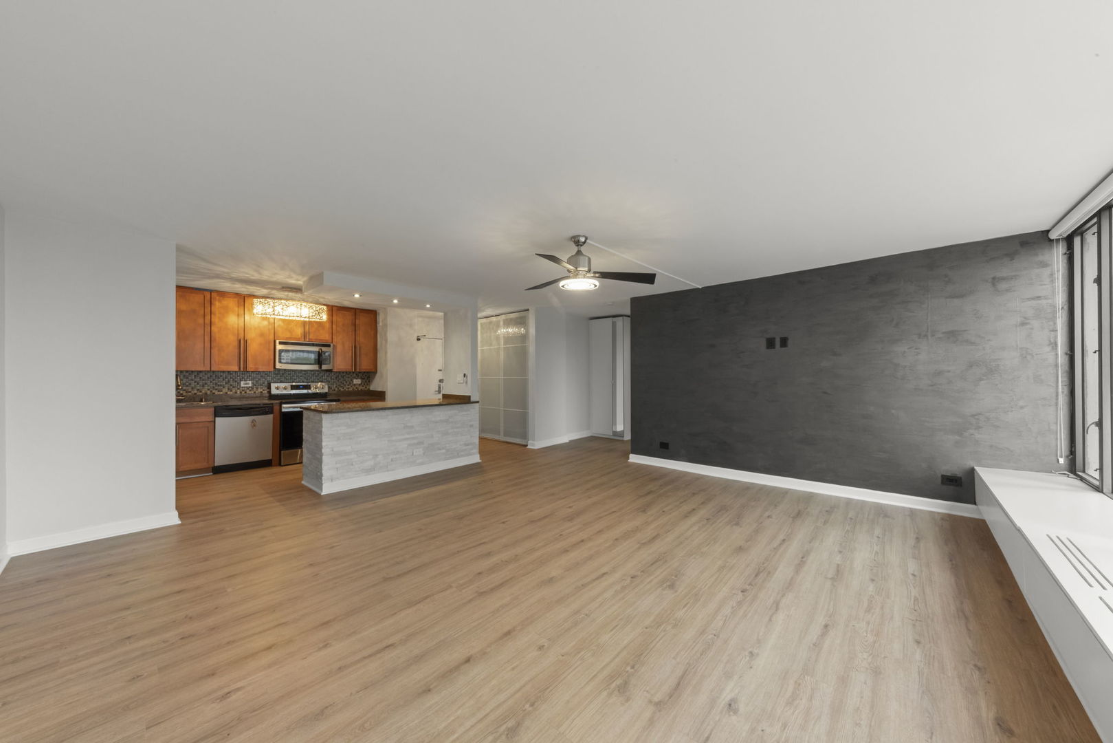 5455 North Sheridan Road, Unit 908 Chicago, IL 60640 - Photo 8 of 21 a view of a kitchen with a sink and a large window