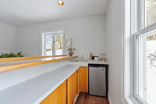 a dining room with furniture a chandelier and wooden floor
