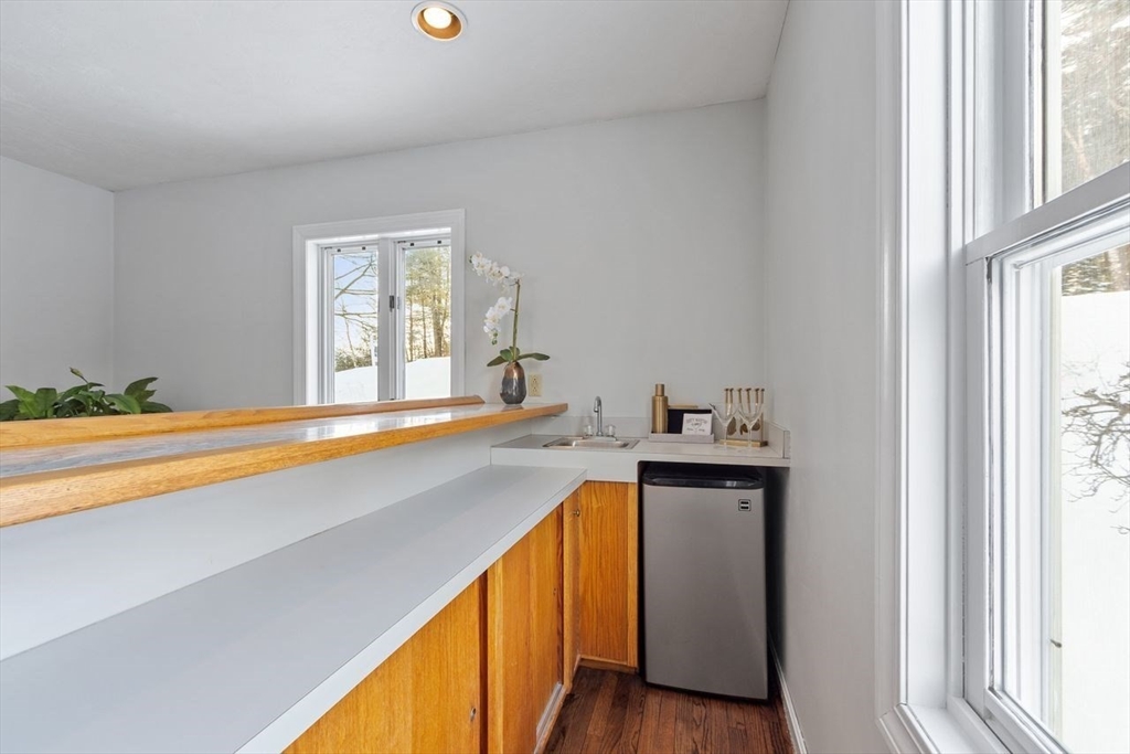 204 Old Farm Road Leominster, MA 01453 - Photo 11 of 40 a view of a kitchen with a sink and wooden floor