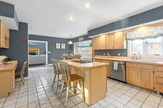 a kitchen with a stove a table and chairs