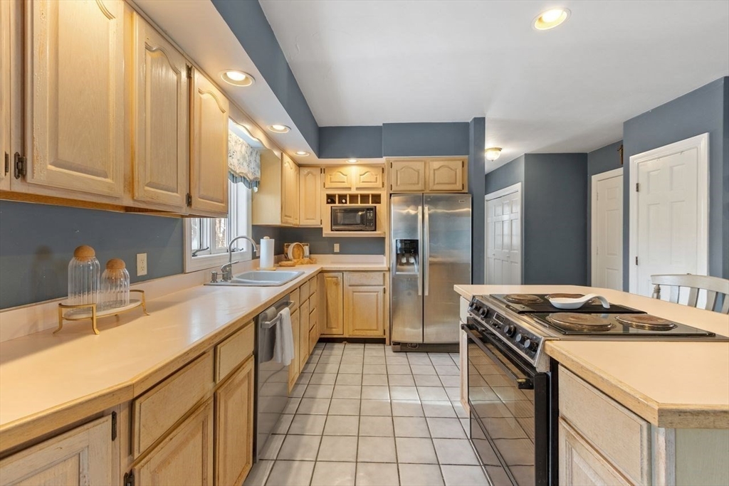 204 Old Farm Road Leominster, MA 01453 - Photo 16 of 40 a kitchen with a sink stove and cabinets