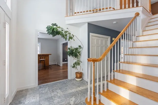 a view of entryway and hall with wooden floor