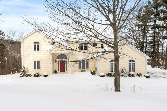 a view of a white house with a snow of the road