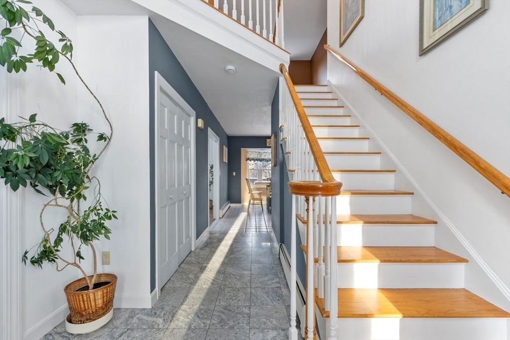 204 Old Farm Road Leominster, MA 01453 - Photo 23 of 40 a view of staircase with lots of frames on wall and potted plant