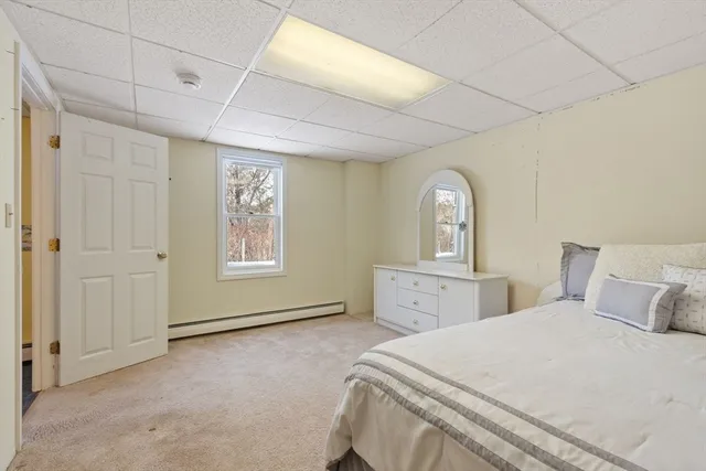 a view of a livingroom with furniture a ceiling fan and window