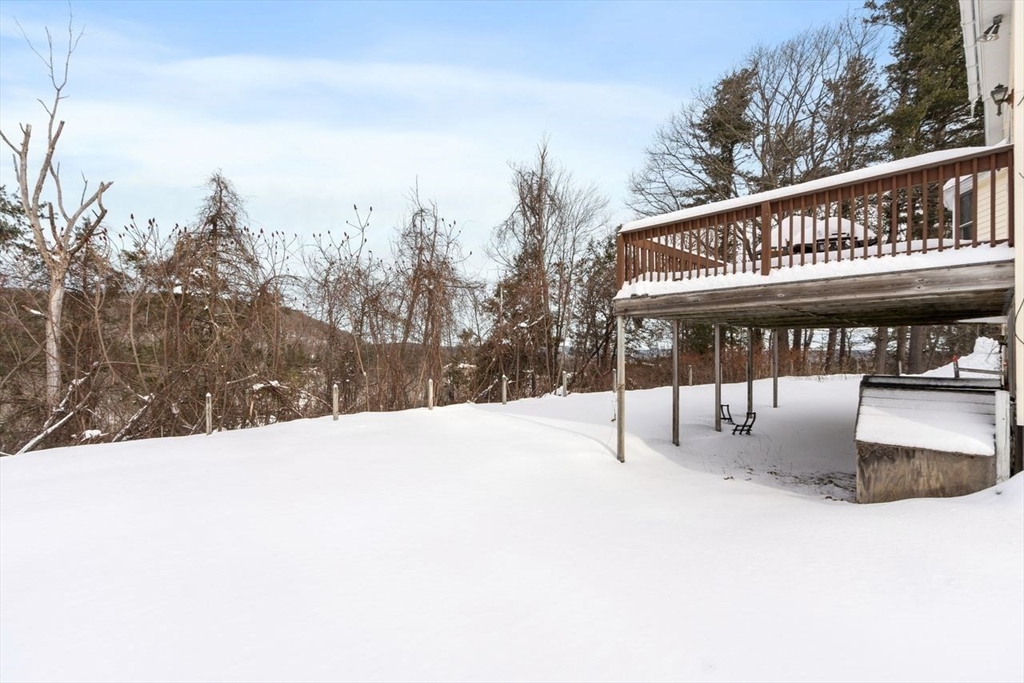 204 Old Farm Road Leominster, MA 01453 - Photo 5 of 40 a roof deck with a yard and covered with snow
