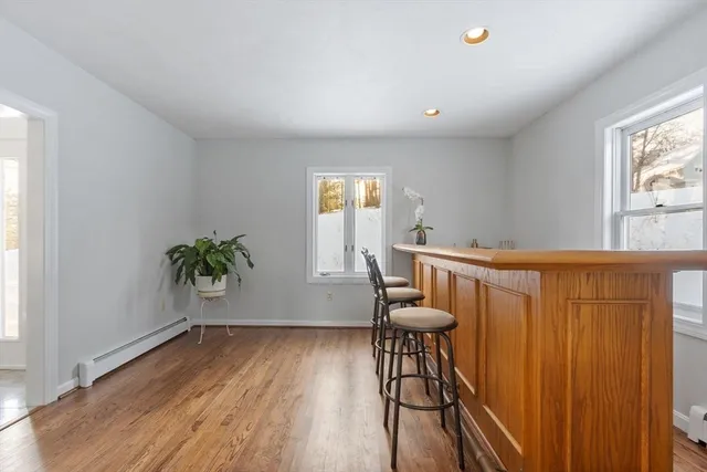 a view of dining room and kitchen with furniture window and wooden floor